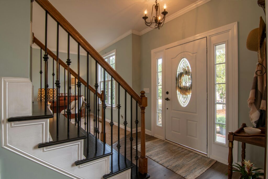 front door in home with chandalier and stairs